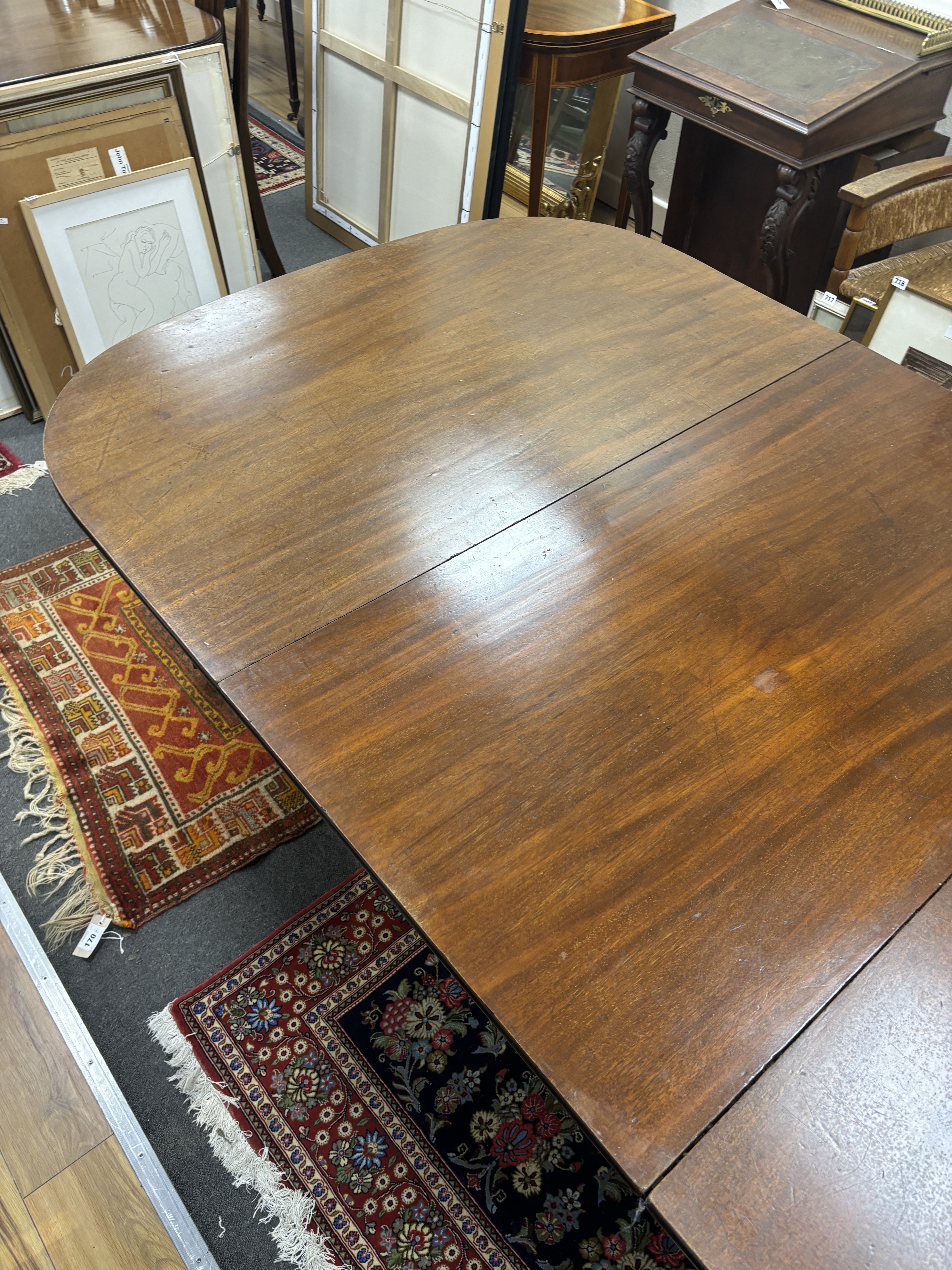 A Regency mahogany twin pillar extending dining table, 208cm extended, one spare leaf (with one other leaf but lacks extension bars, depth 116cm, height 71cm